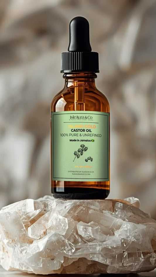 Island Gold 100% pure, unrefined Jamaican Black Castor Oil from St. Elizabeth, Jamaica, in a 2 fl oz (59 mL) bottle, featuring IsleAura & Co. branding and traditional Jamaican castor oil heritage.