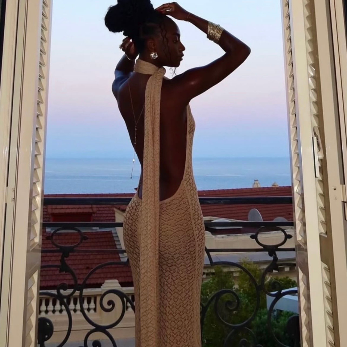 Woman in a long, light-colored dress standing on a balcony with a scenic view.Woman sitting on a vintage car holding flowers, with a building and sign in the background.    Discover pleasure products in Trinidad and Tobago from Belle Exotics, including couple toys, lubricants, lingerie, and beginner-friendly adult products.