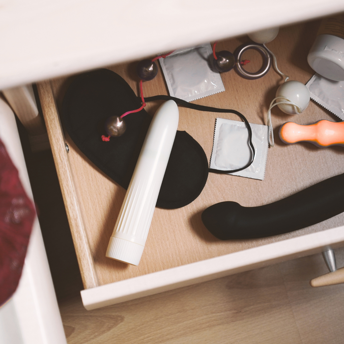 Open drawer with various adult toys including a white vibrator, black mask, and other massage wand.  Belle Exotics is a discreet adult toy and sexual wellness store in Trinidad and Tobago, offering pleasure products, lubricants, lingerie, couple toys, self-love essentials, and intimacy accessories for private online and in-store shopping.   Belle Exotics offers discreet adult toys, lubricants, lingerie, and sexual wellness products in Trinidad and Tobago for online and in-store shopping.