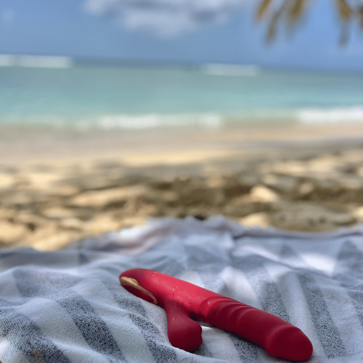 Red rabbit vibrator on a towel with a beach in the background.Promotional image for a Belle Exotics Anniversary with text overlay and a person in a white dress.Promotional advertisement for a Trinidad & Tobago pleasure store with text and a person in a yellow top. Anniversary Campaign  by Belle Exotics in Trinidad and Tobago promoting confident exploration, sexual wellness, and guided intimacy in-store and online.