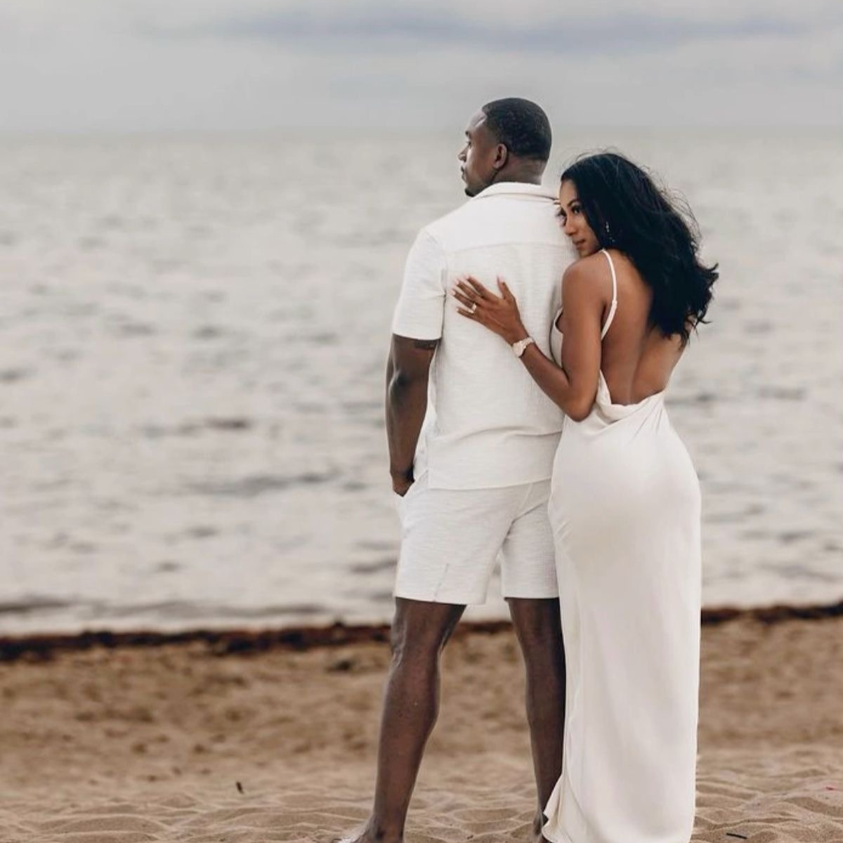 Couple standing on a beach, both wearing white outfits.   Discover pleasure products in Trinidad and Tobago from Belle Exotics, including couple toys, lubricants, lingerie, and beginner-friendly adult products.