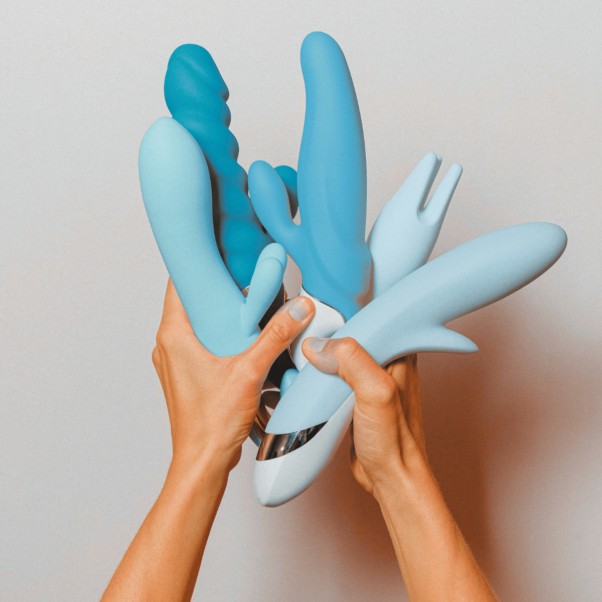 Blue silicone rabbit vibrator held by hands against a neutral background.Discover Belle Exotics, your destination for luxury adult toys and wellness products. Shop discreetly in Trinidad and Tobago with fast, private delivery. Elevate intimacy today.