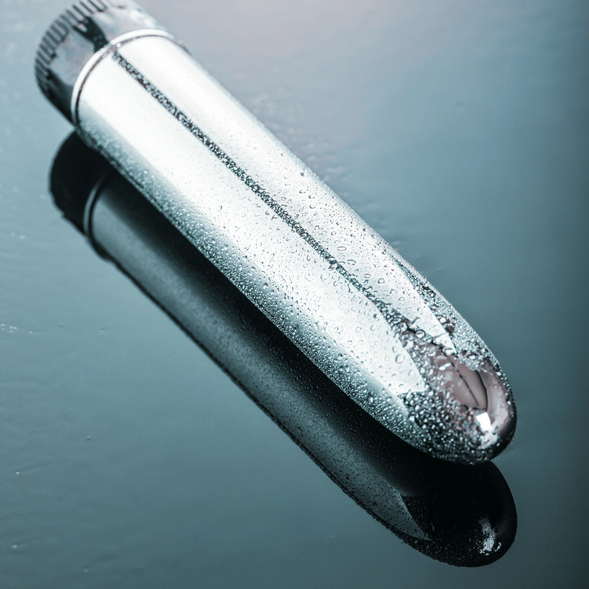 Metallic vibrator with a reflective surface on a dark background. Your Blissful Holidays.Belle Exotics holiday sale – sensual gifts, couples toys, and self-care essentials. Private delivery nationwide.

