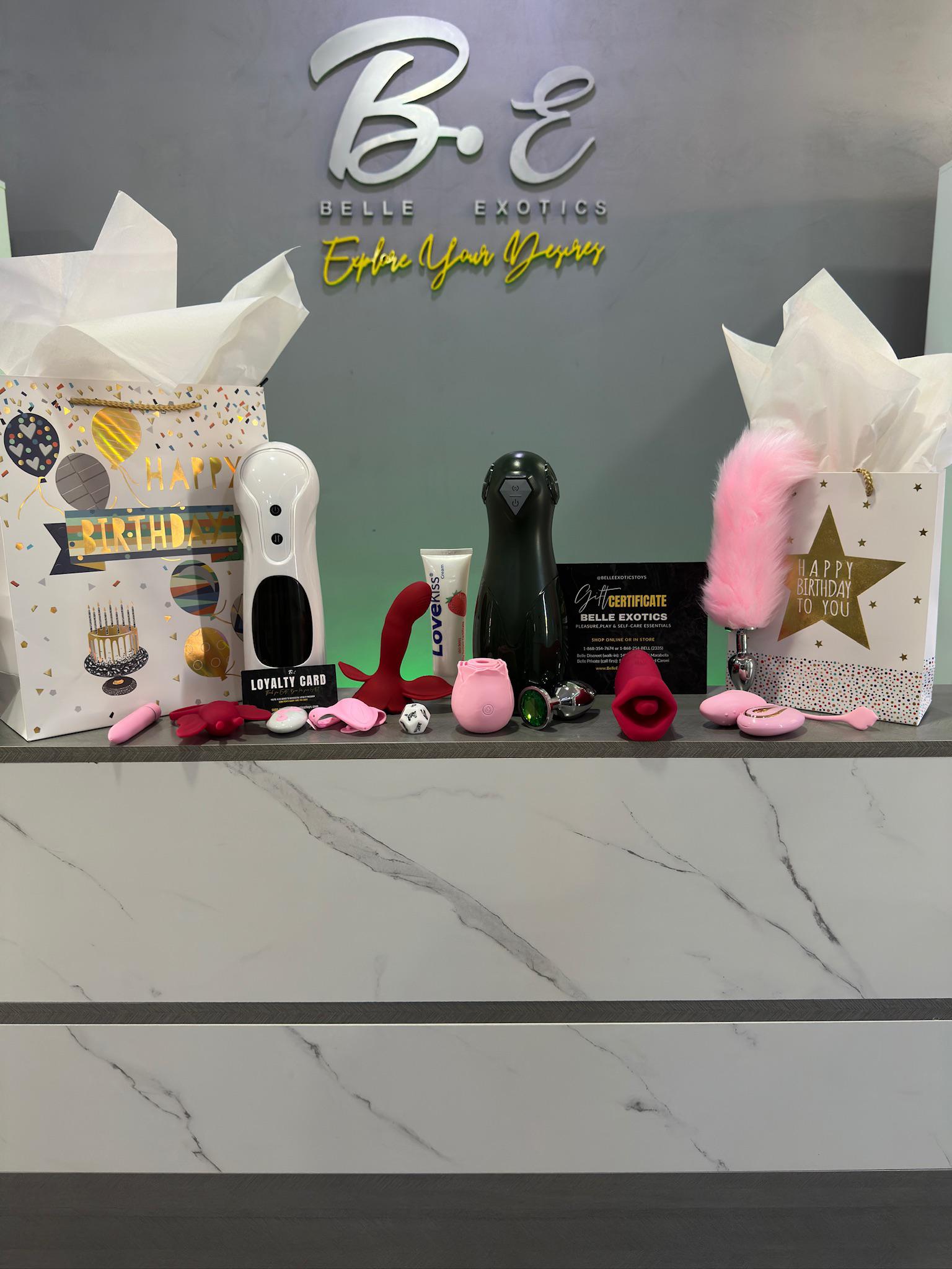 Display of various products on a counter with 'Belle Exotica' branding in the background.