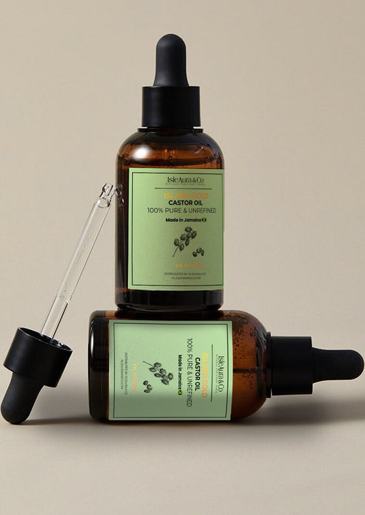 Island Gold 100% pure, unrefined Jamaican Black Castor Oil from St. Elizabeth, Jamaica, in a 2 fl oz (59 mL) bottle, featuring IsleAura & Co. branding and traditional Jamaican castor oil heritage.